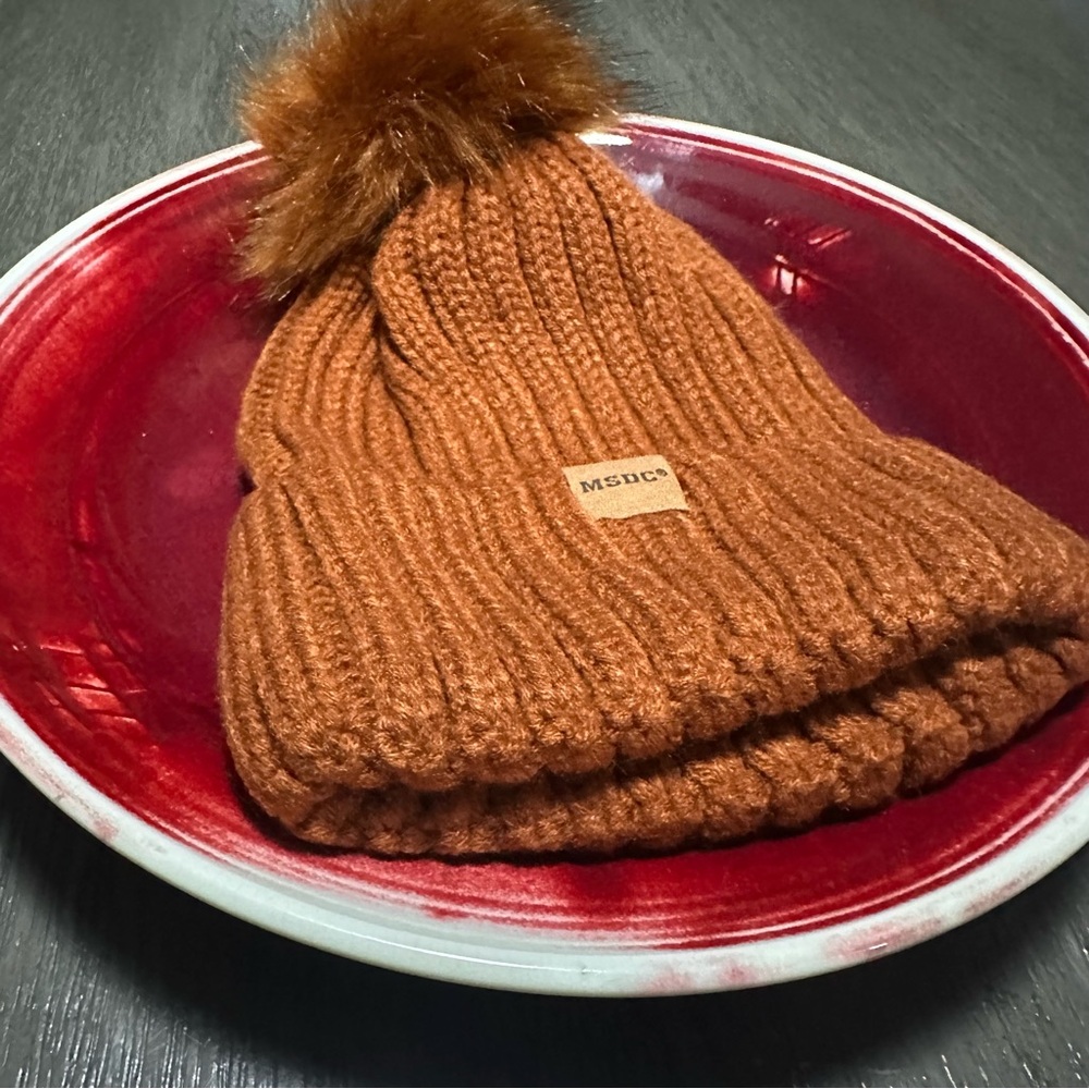 Brand New MSDC Women's Knit Rust Color Beanie featuring a Playful Pom-Pom
